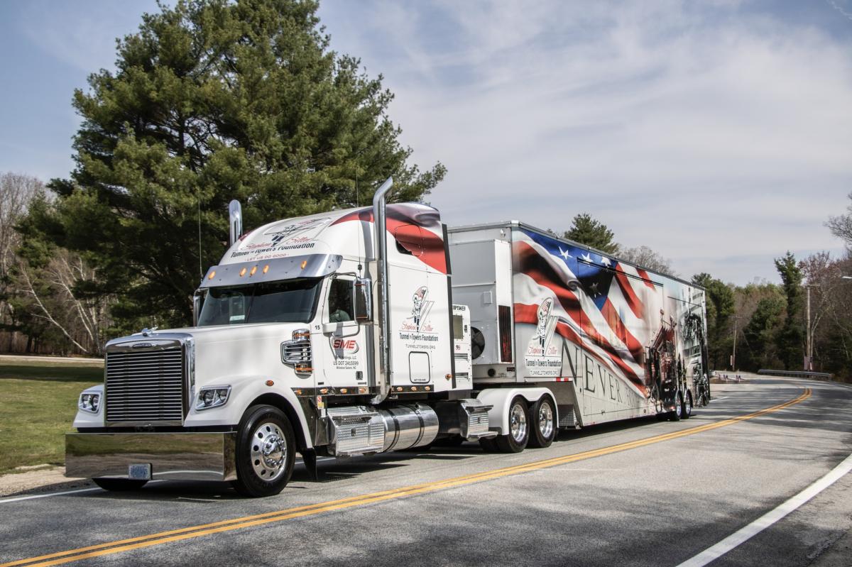 A tractor trailer decorated with the American flag