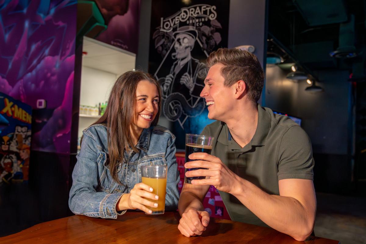 Couple enjoying draft beer and food at Lovedraft's