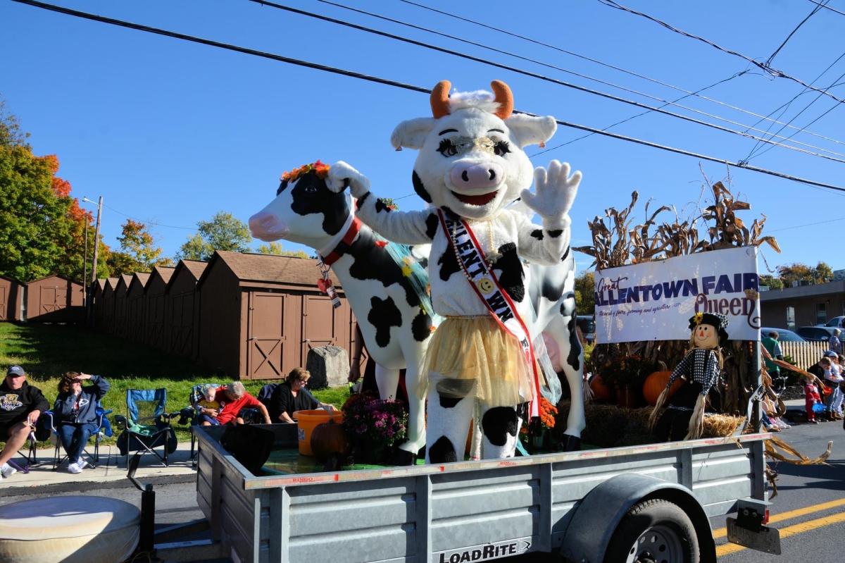 Moodonna, The Great Allentown Fair mascot, waves to the crowd atop a parade float
