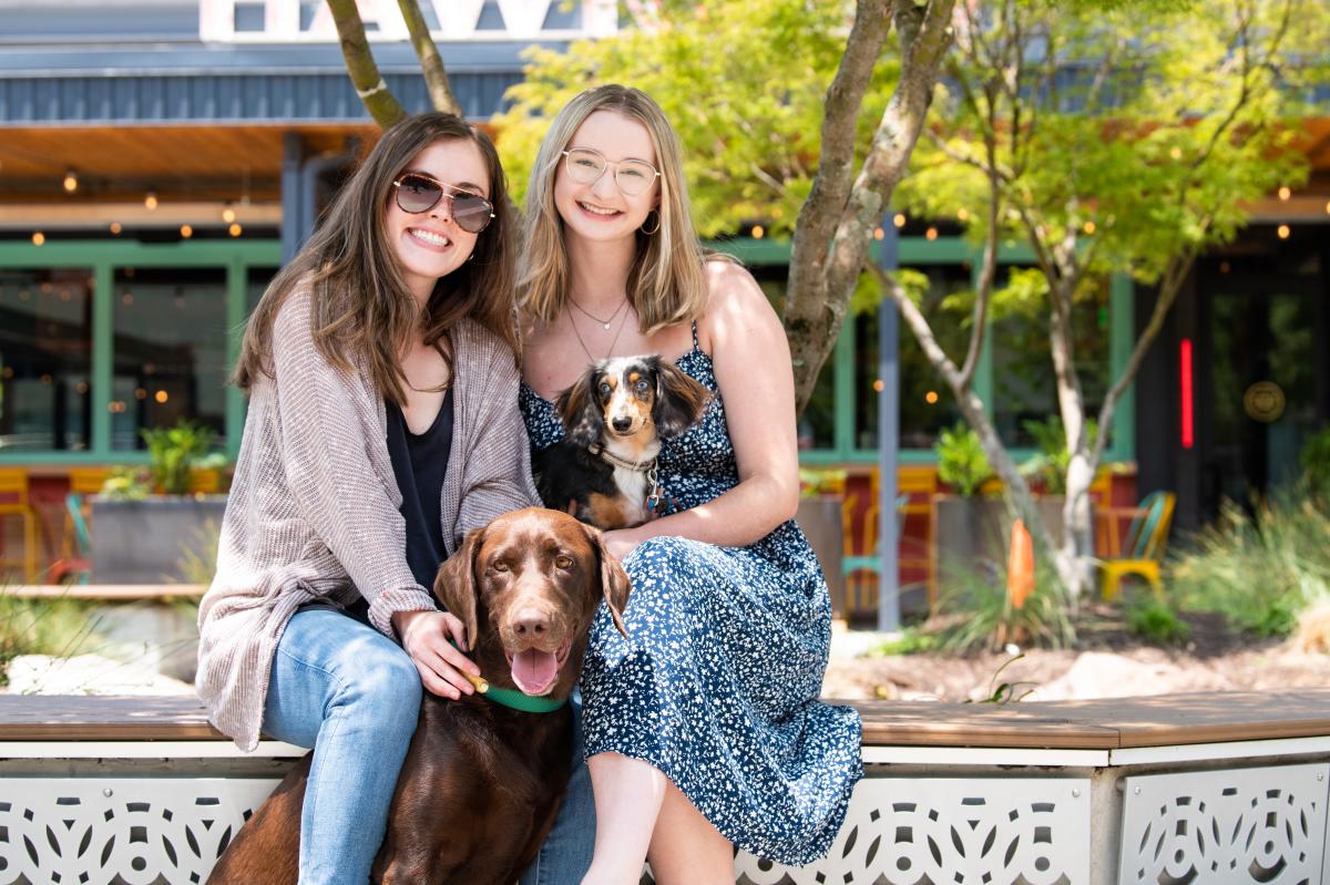 Ashford Lane Dog Day Two Women Pose with their Dogs for the Camera