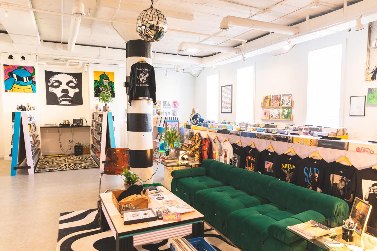 a photo inside the record lounge showing a couch, vintage t-shirts, records, and more