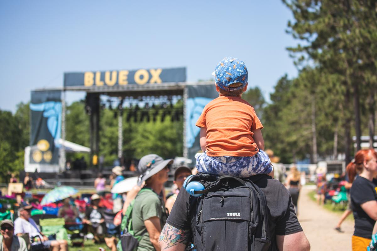 A young boy sitting on dad's shoulders at Blue Ox Music Festival in Eau Claire