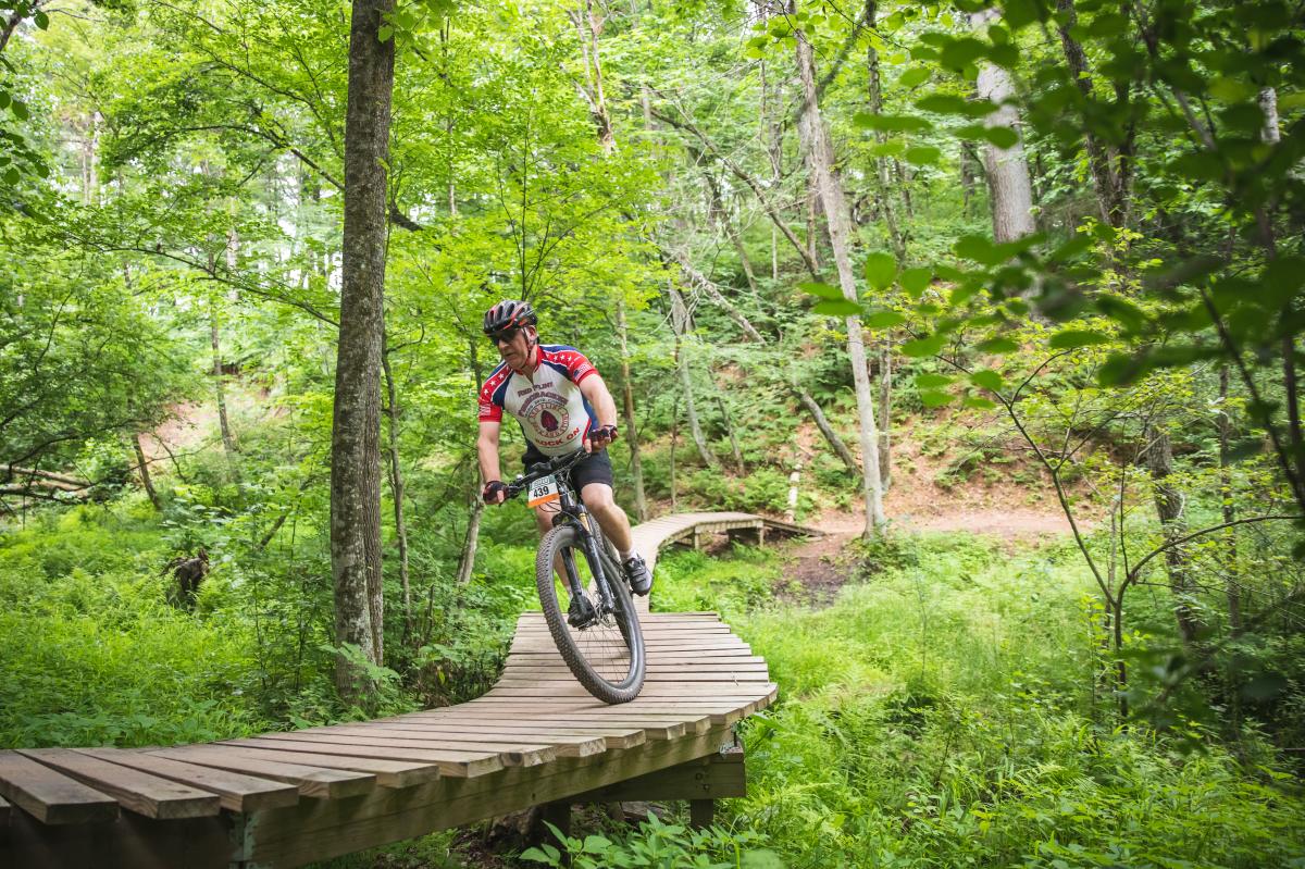 A man riding his bike in a CORBA race at Lowes Creek County Park in Eau Claire