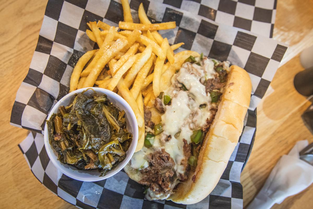 A photo of a Philly Cheese Steak with fries