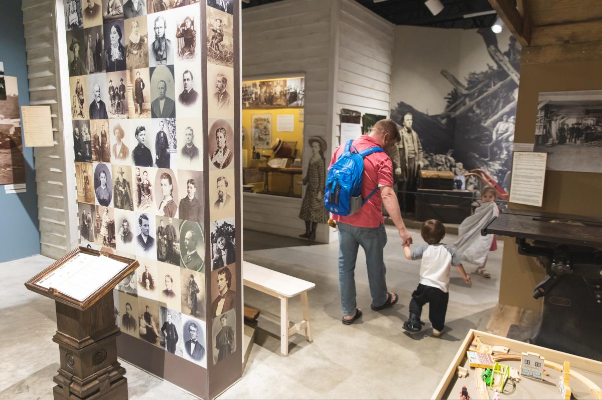 a dad walking with his son and daughter through the Chippewa Valley Museum