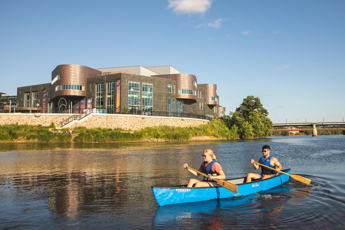 A man and woman canoeing at the confluence of the Eau Claire and Chippewa Rivers