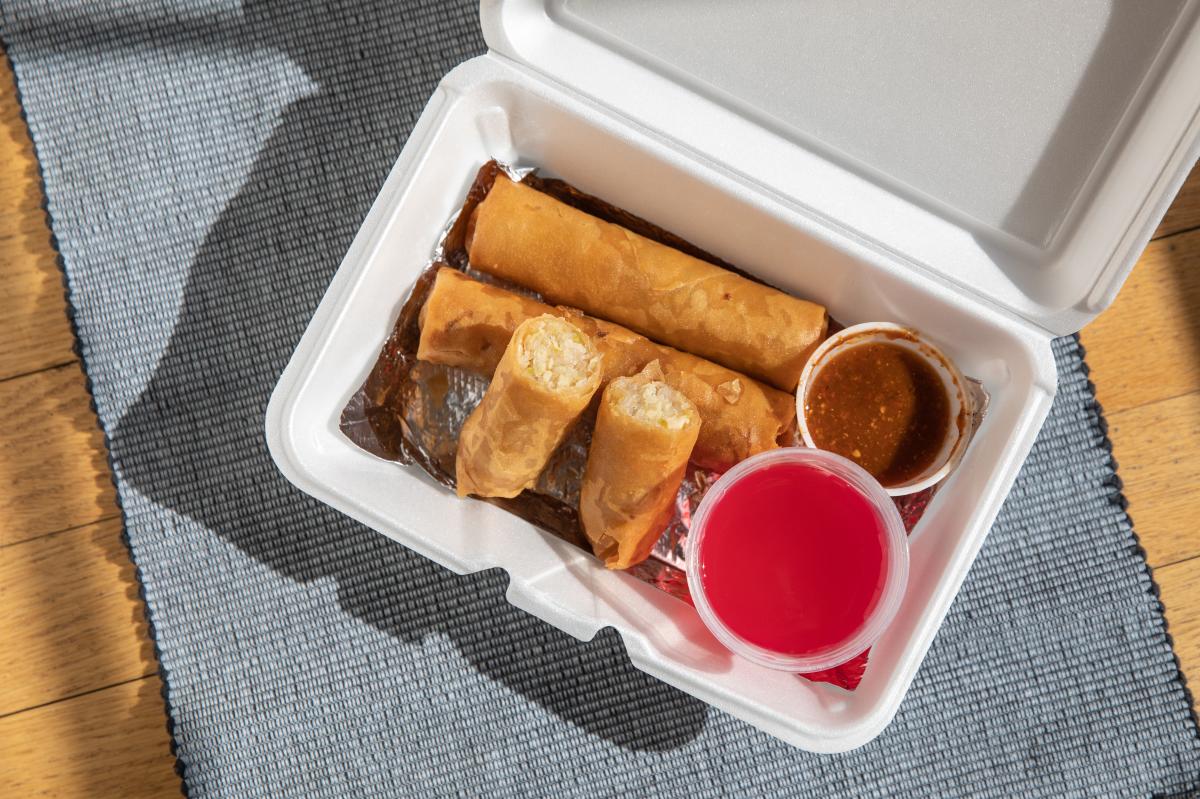 Egg rolls served in a takeout box from Egg Roll Plus