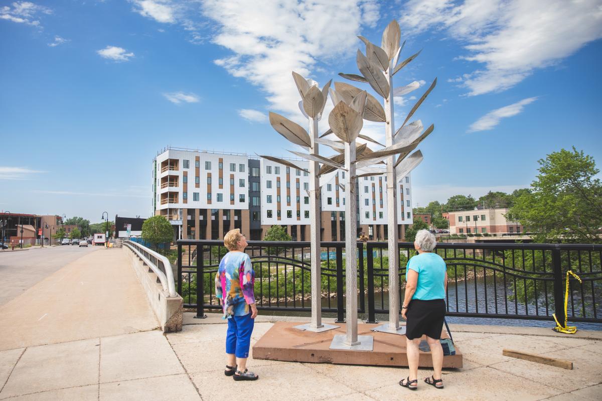 Two women looking at a sculpture in downtown Eau Claire