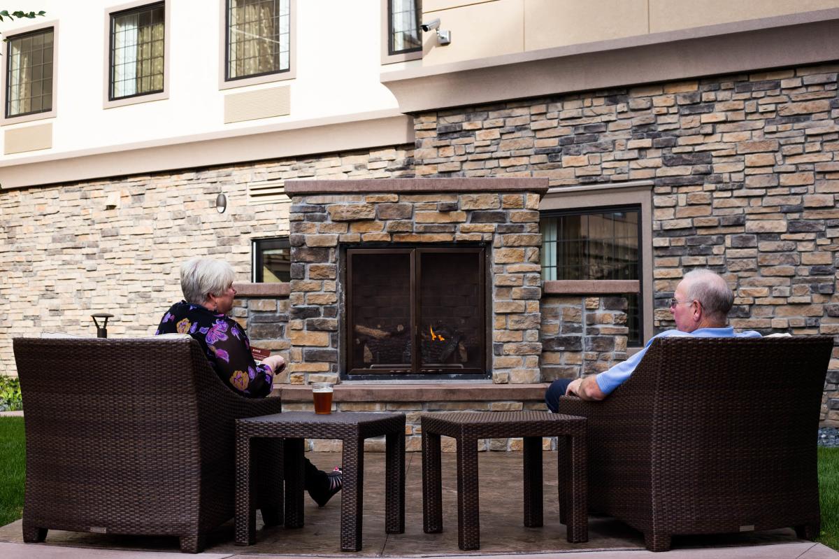 Relaxing in front of outdoor fireplace at Staybridge Suites in Altoona, WI