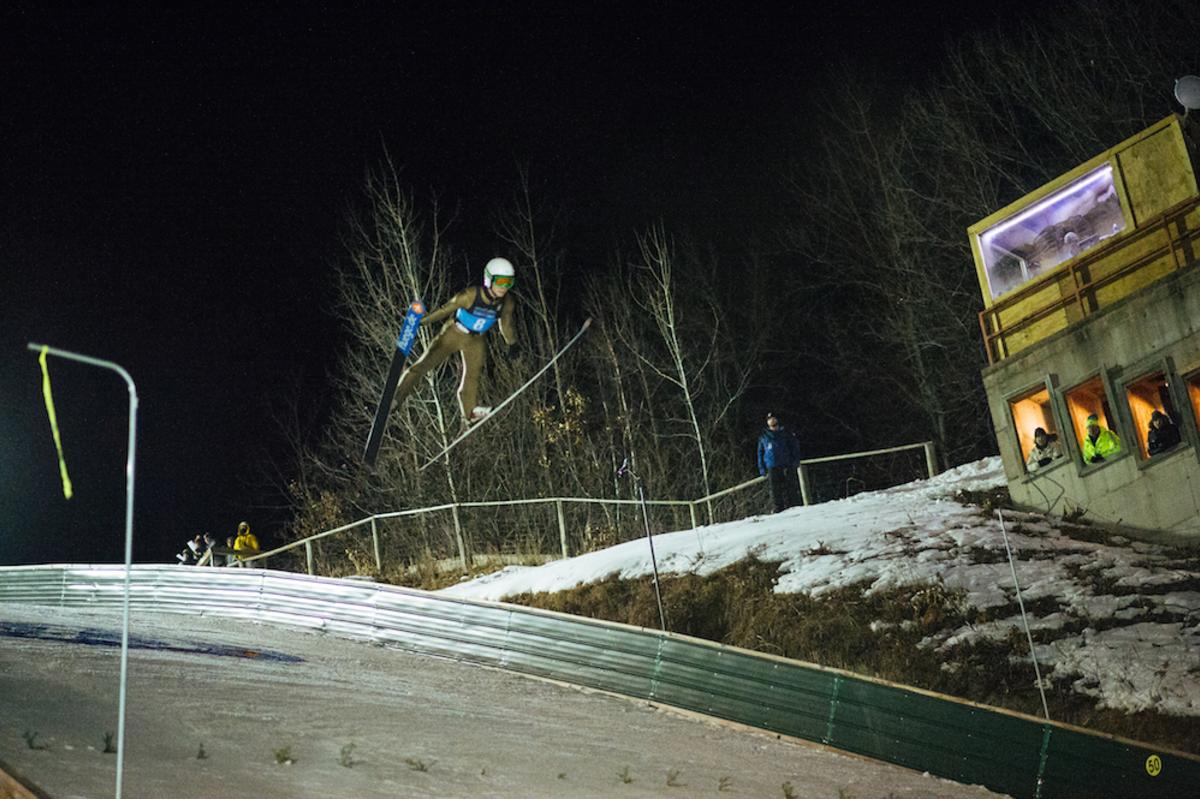 A person doing a ski jump at the Silver Mine Ski Invitational