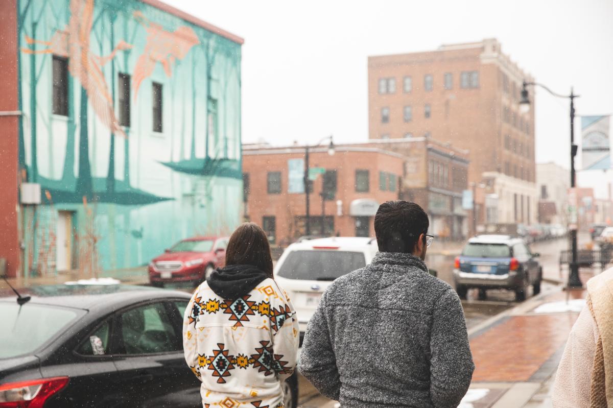 A girl and guy walking the streets of downtown Eau Claire