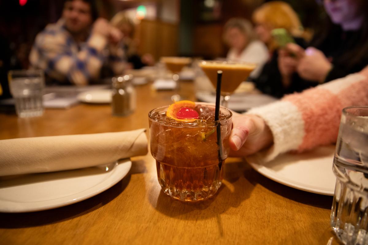 A person holding an Old Fashioned at Houligans