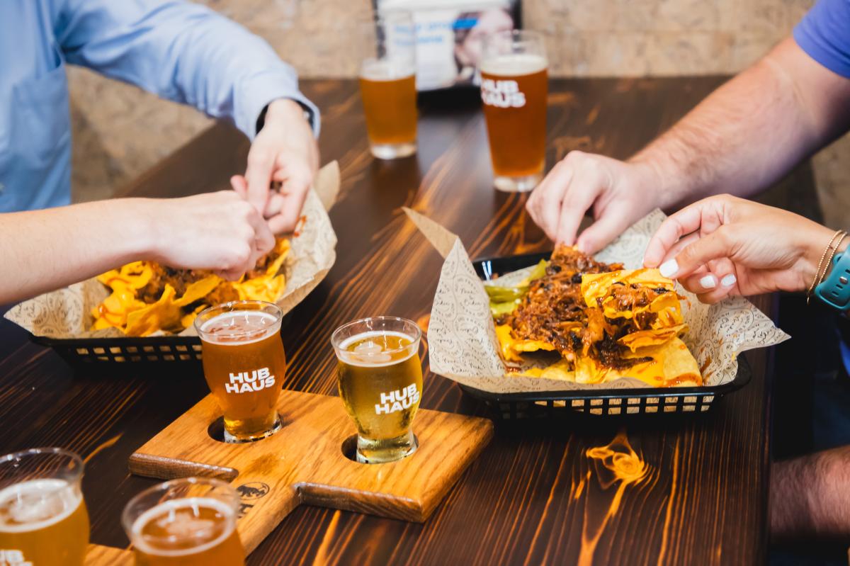 people having nachos and beer at hubhaus