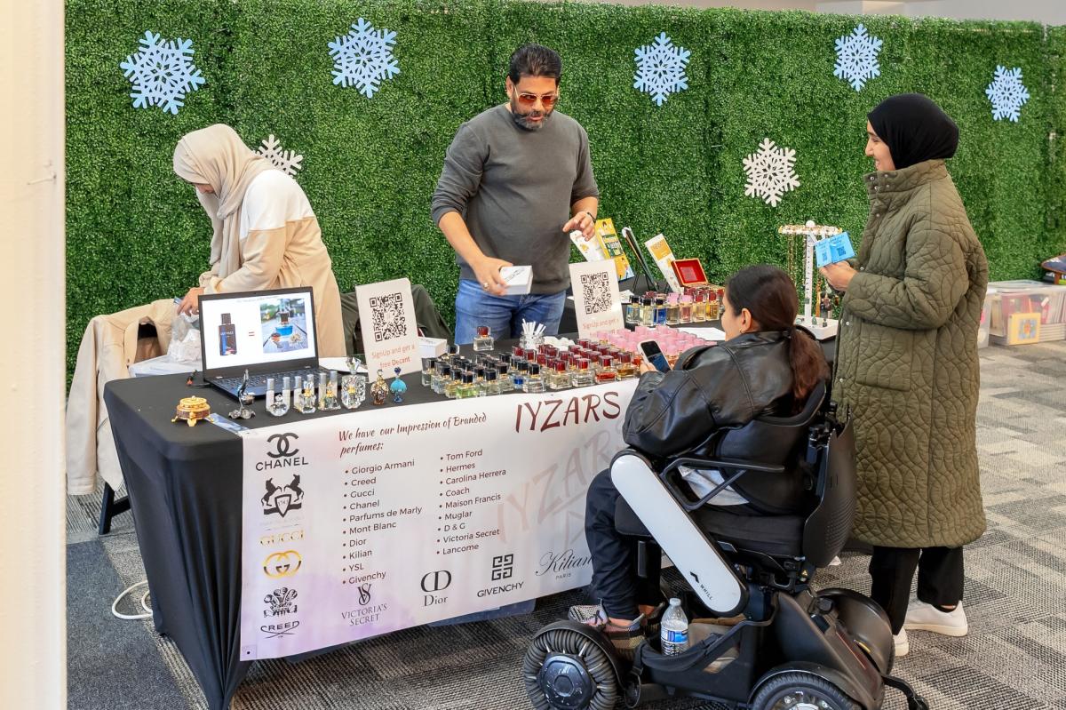 Local artisan selling their perfumes to customers.