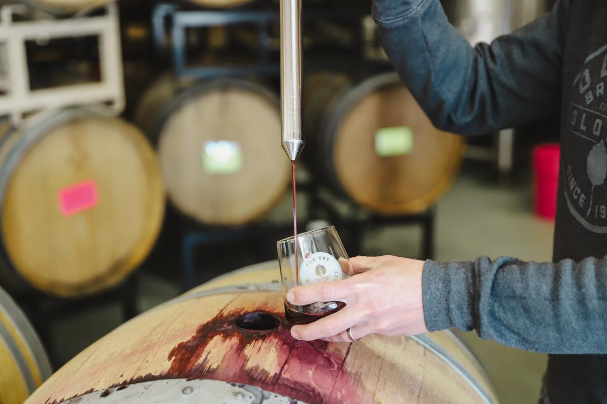 Wine  glass being filled from the barrel
