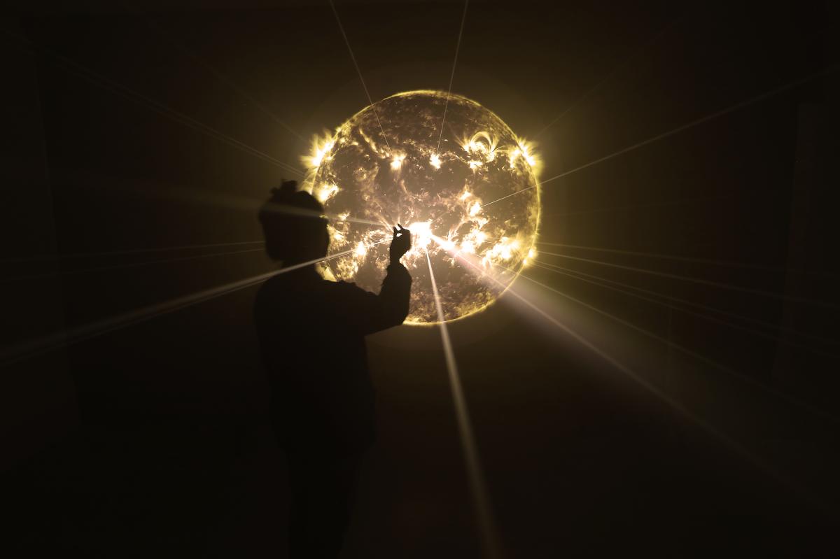 A person interacting with an art exhibit from IGNITE Broward 2026