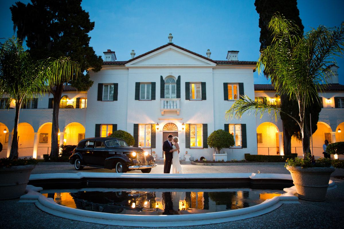 A couple posing for a picture in front of a Georgia resort after being married