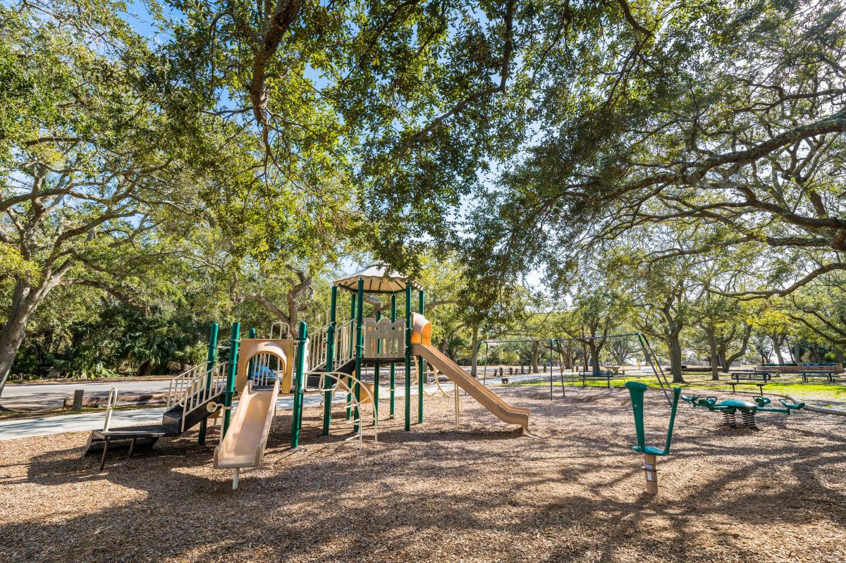 A shady playground can be found adjacent to the beach at Massengale Park on St. Simons Island, GA