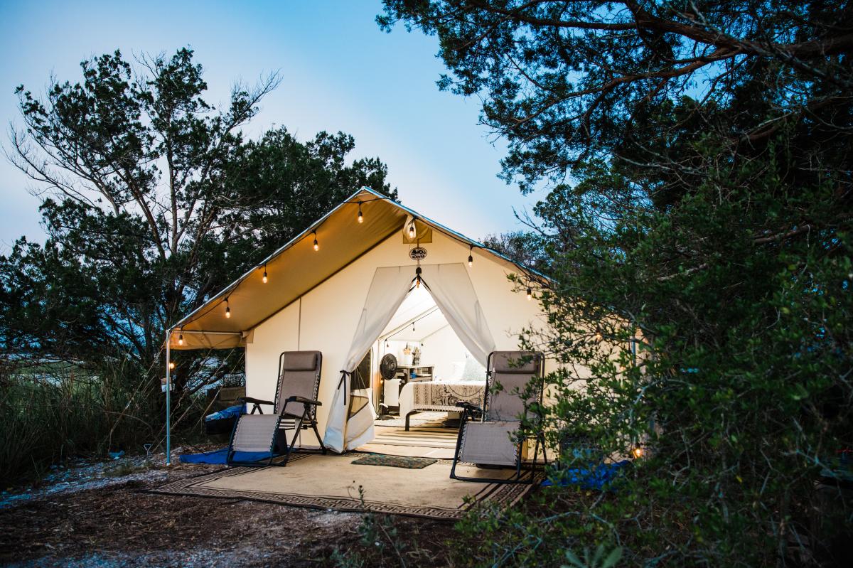 A outside shot of a yurt with two lounge chairs in Little Raccoon Key.