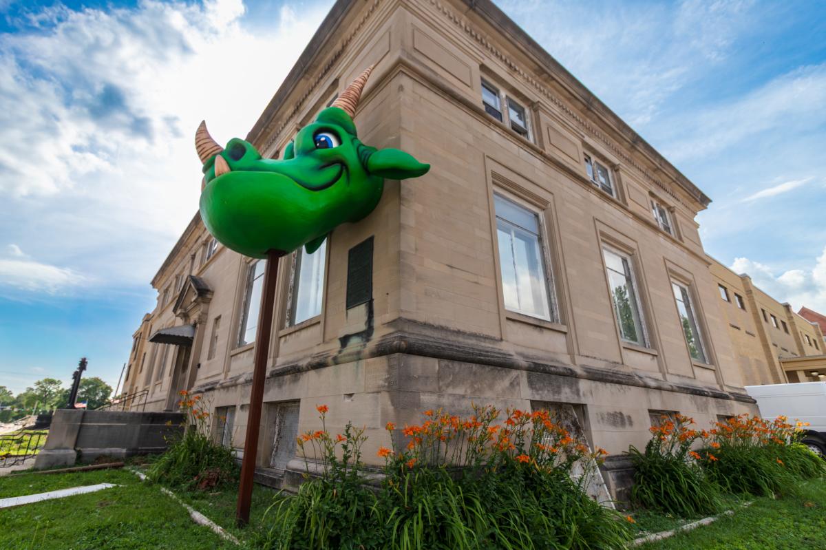 Exterior of TCB Games game store in Huntington, showing off the big green dragon head