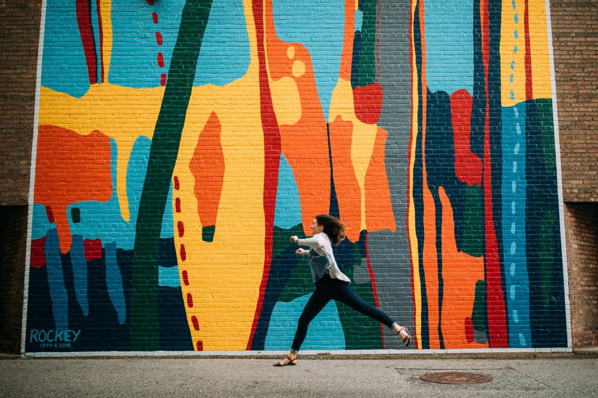 Woman in front a mural