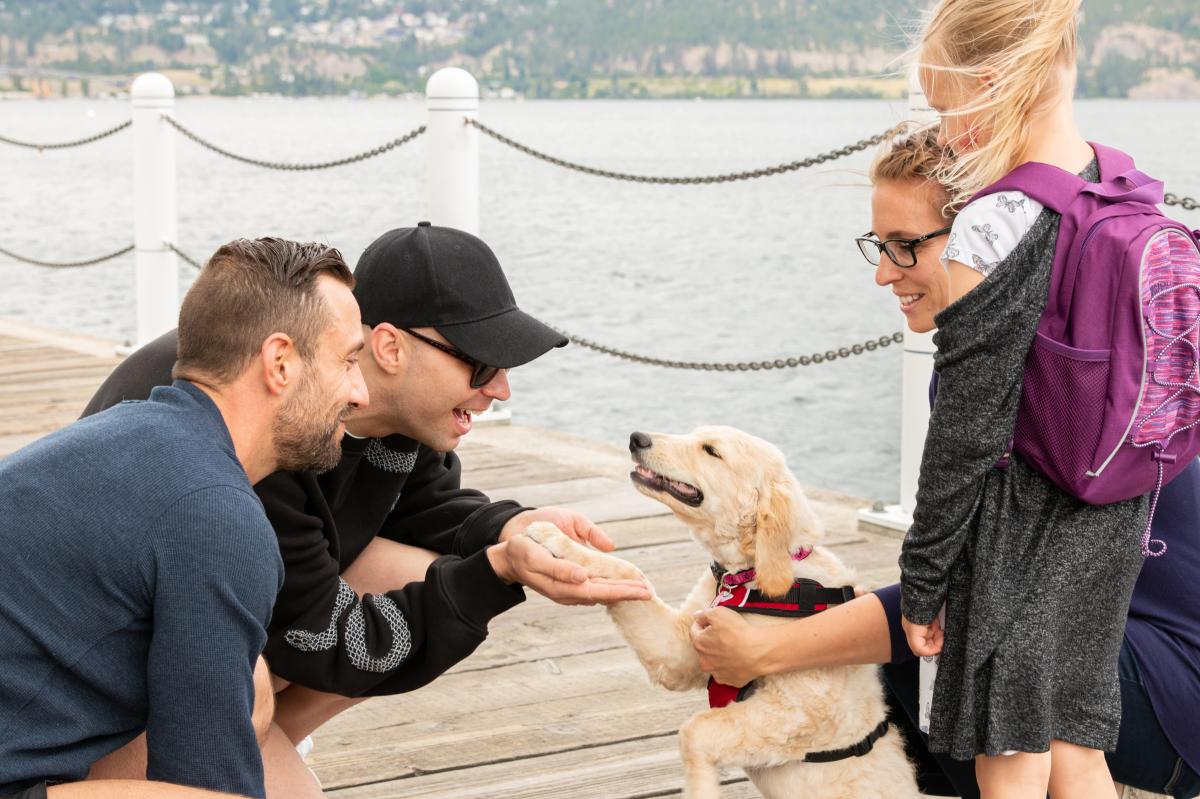 Brock Hayhoe (Brooke Lynn Hytes) with dog on boardwalk