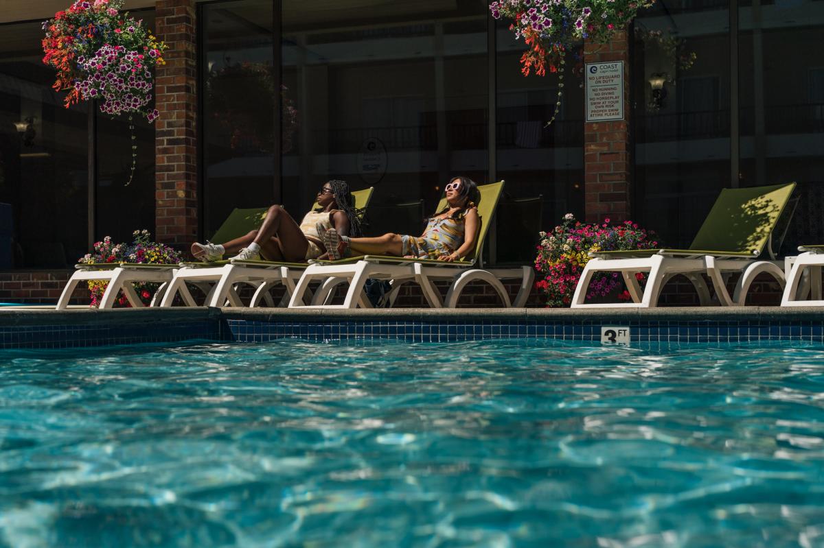 People Relaxing at Coast Capri Hotel Pool