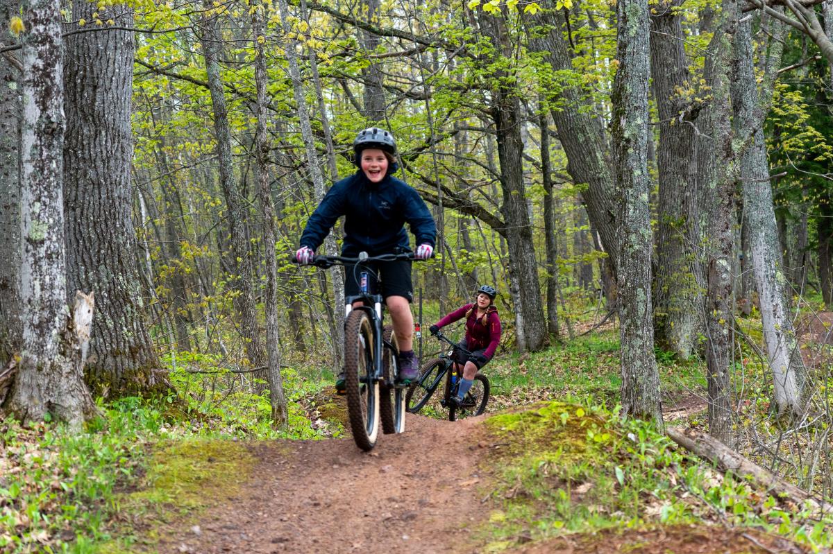 Two youth bike the trails at MTU.