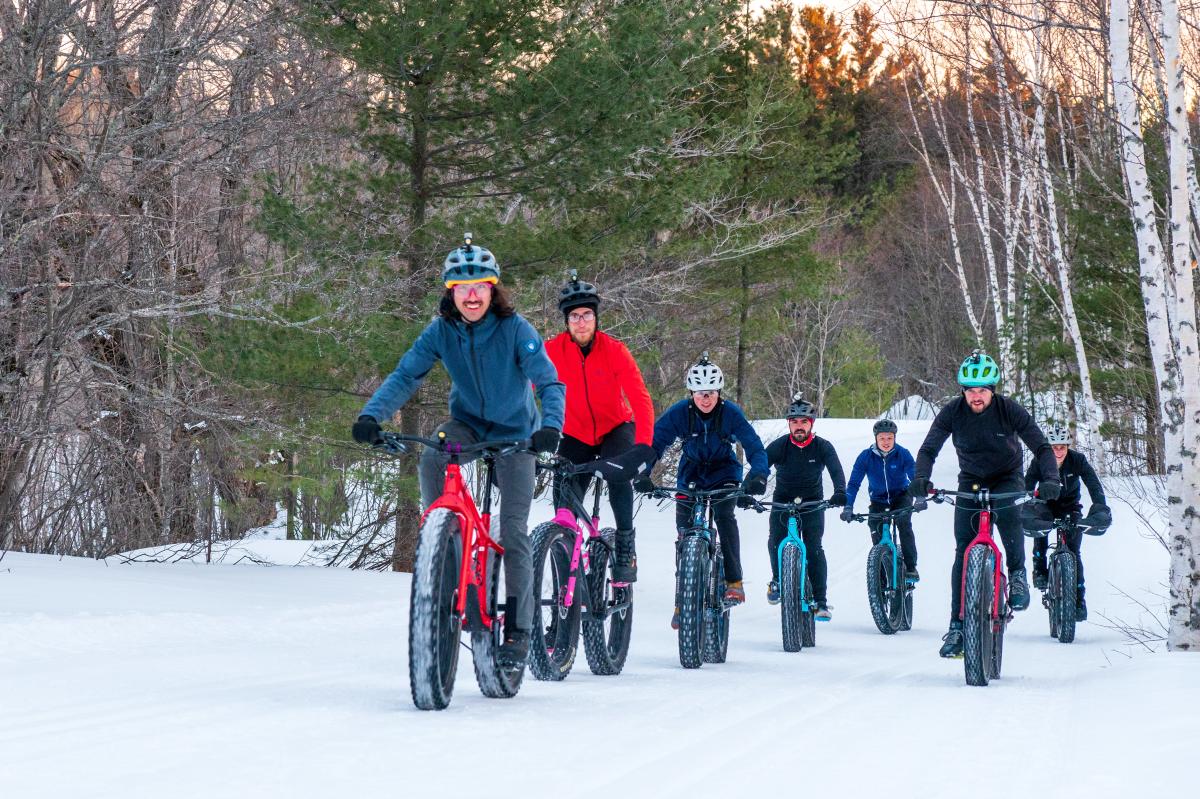 Group rides fat-tire bikes through the snow