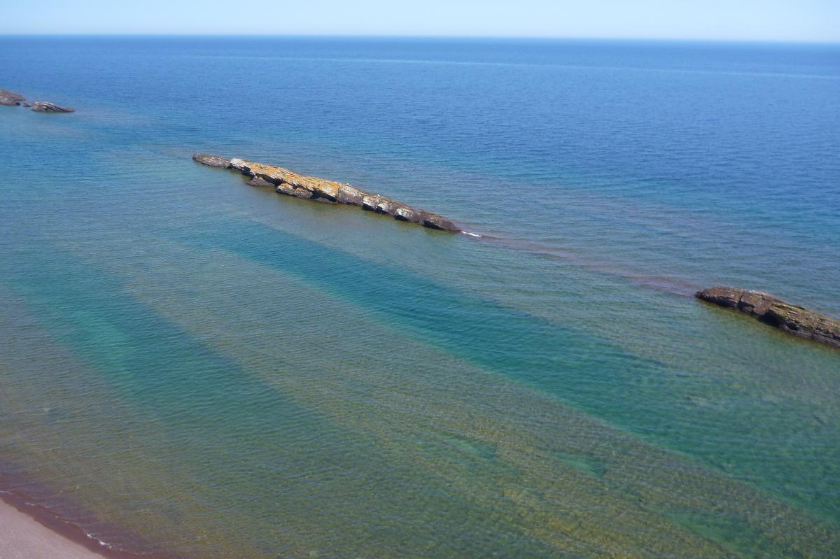 aerial views of the volcanic rock outcroppings along the lake's shoreline