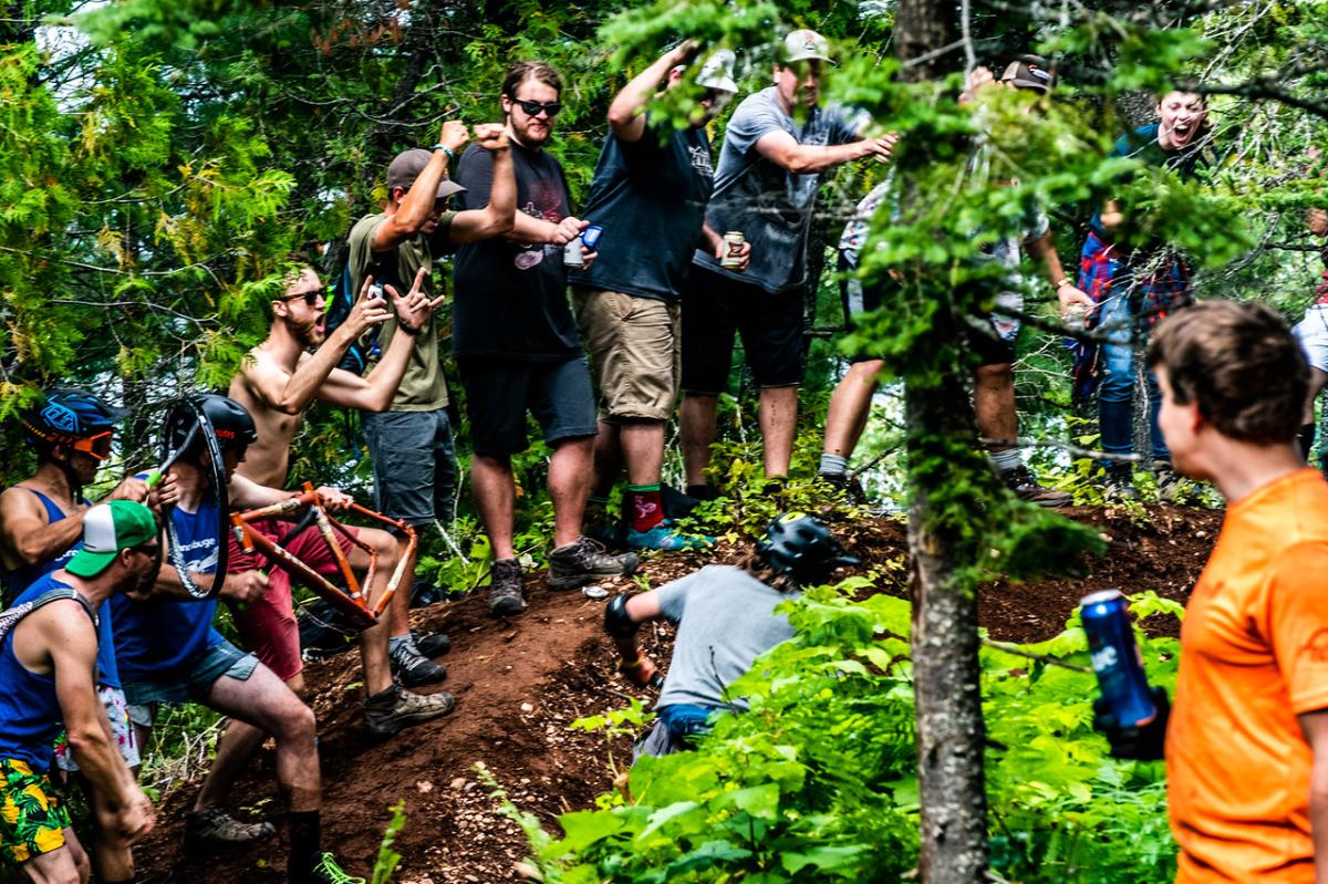 Spectators encourage racers up the hill during mountain biking race