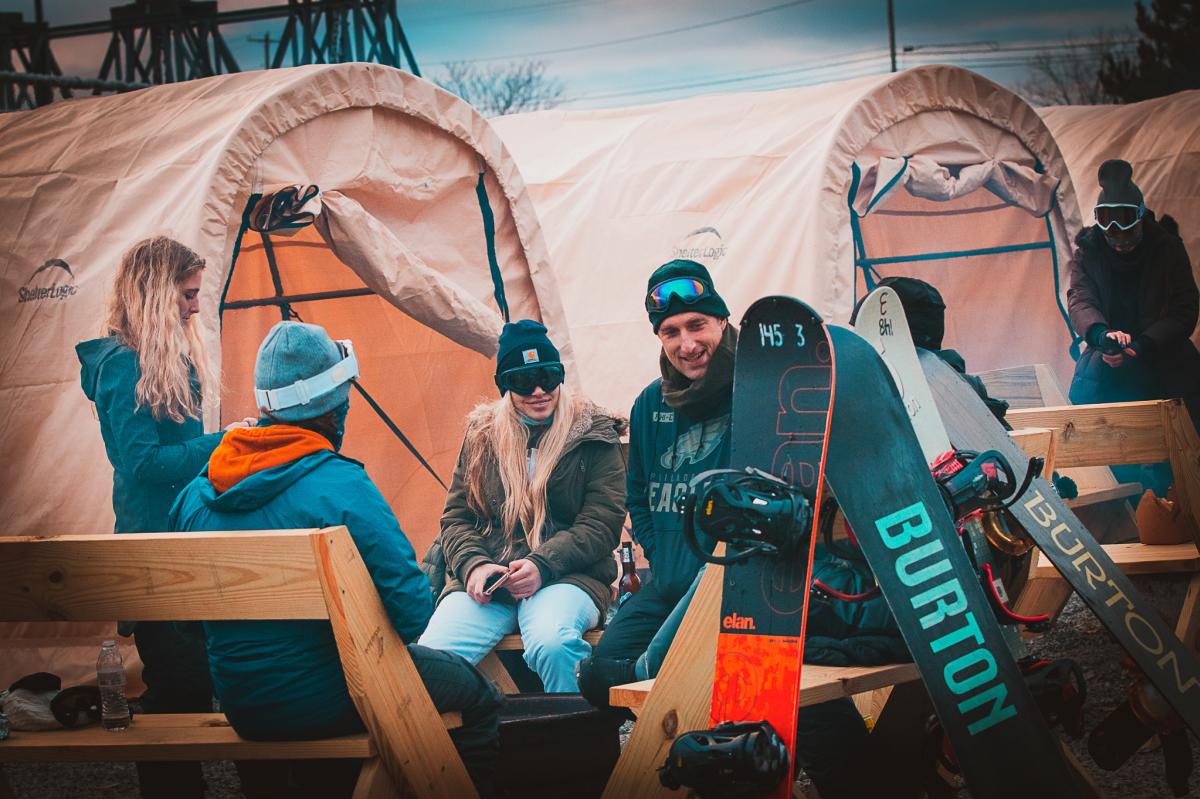 snowboarders sitting around a fire pit at Midland at Montage Mountain Resorts in Scranton, PA