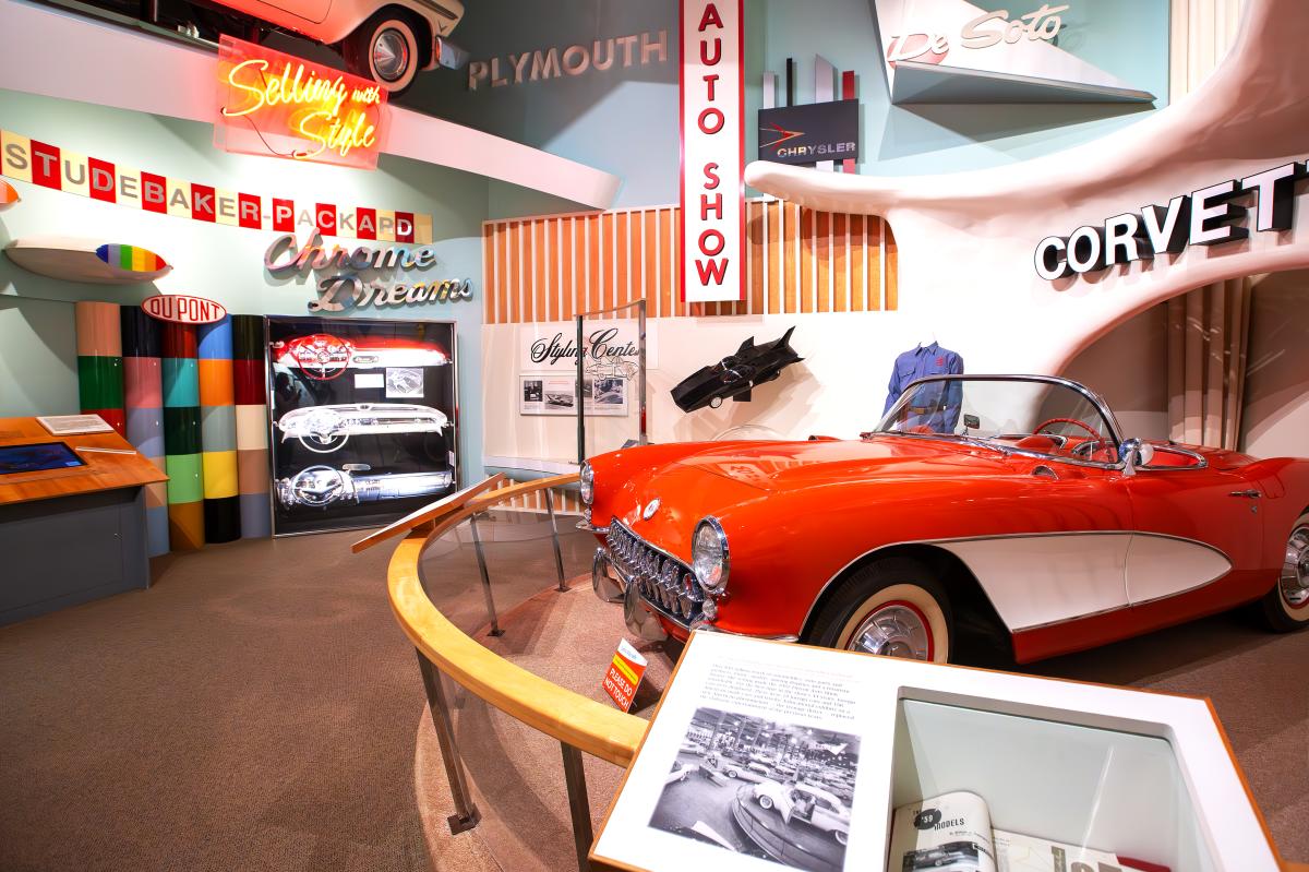 Displays of Michigan's automobile history, including a red Corvette, at the Michigan History  Museum