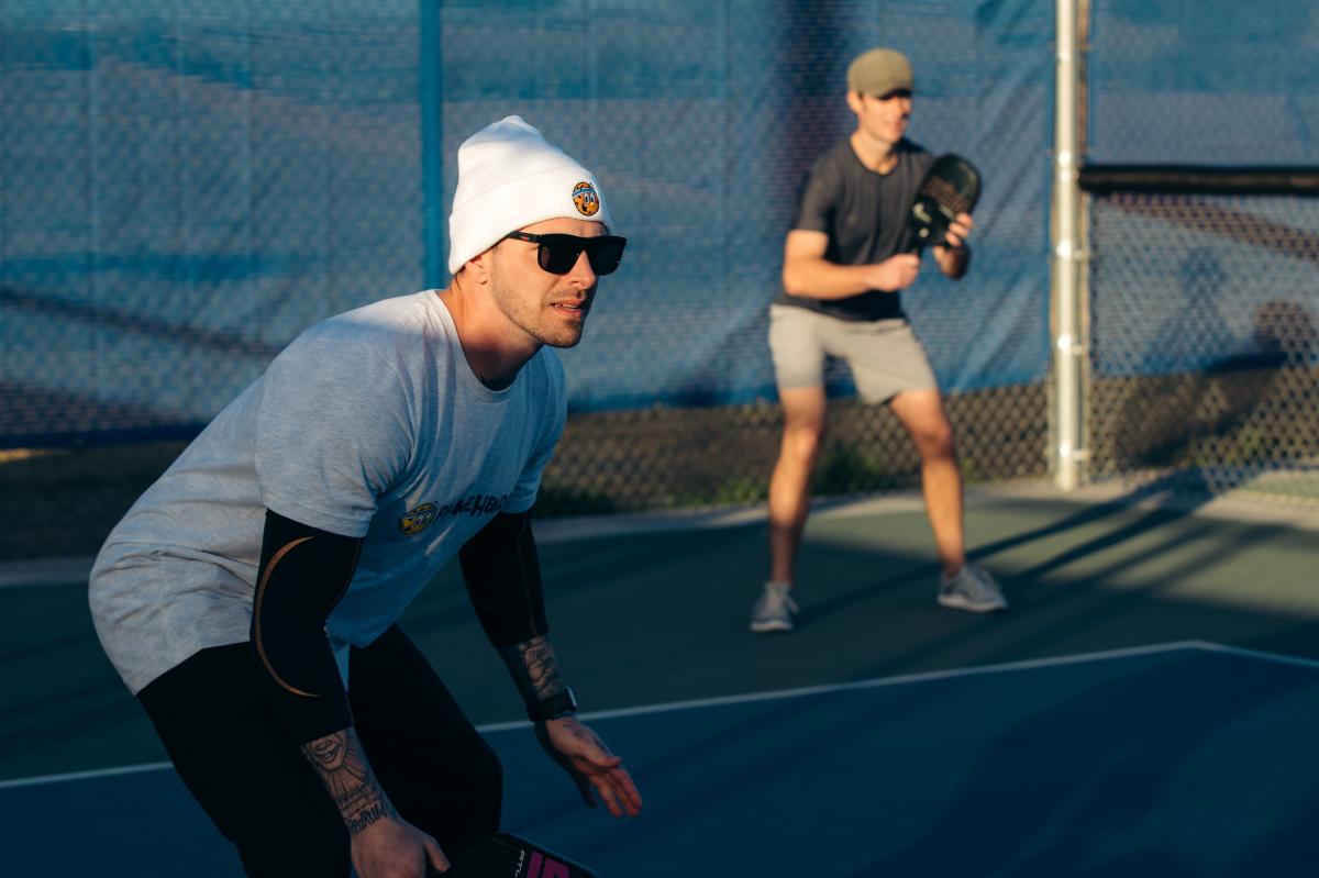 Two people playing pickleball