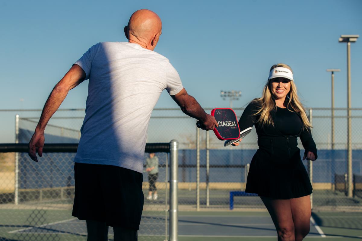 Two people playing pickleball