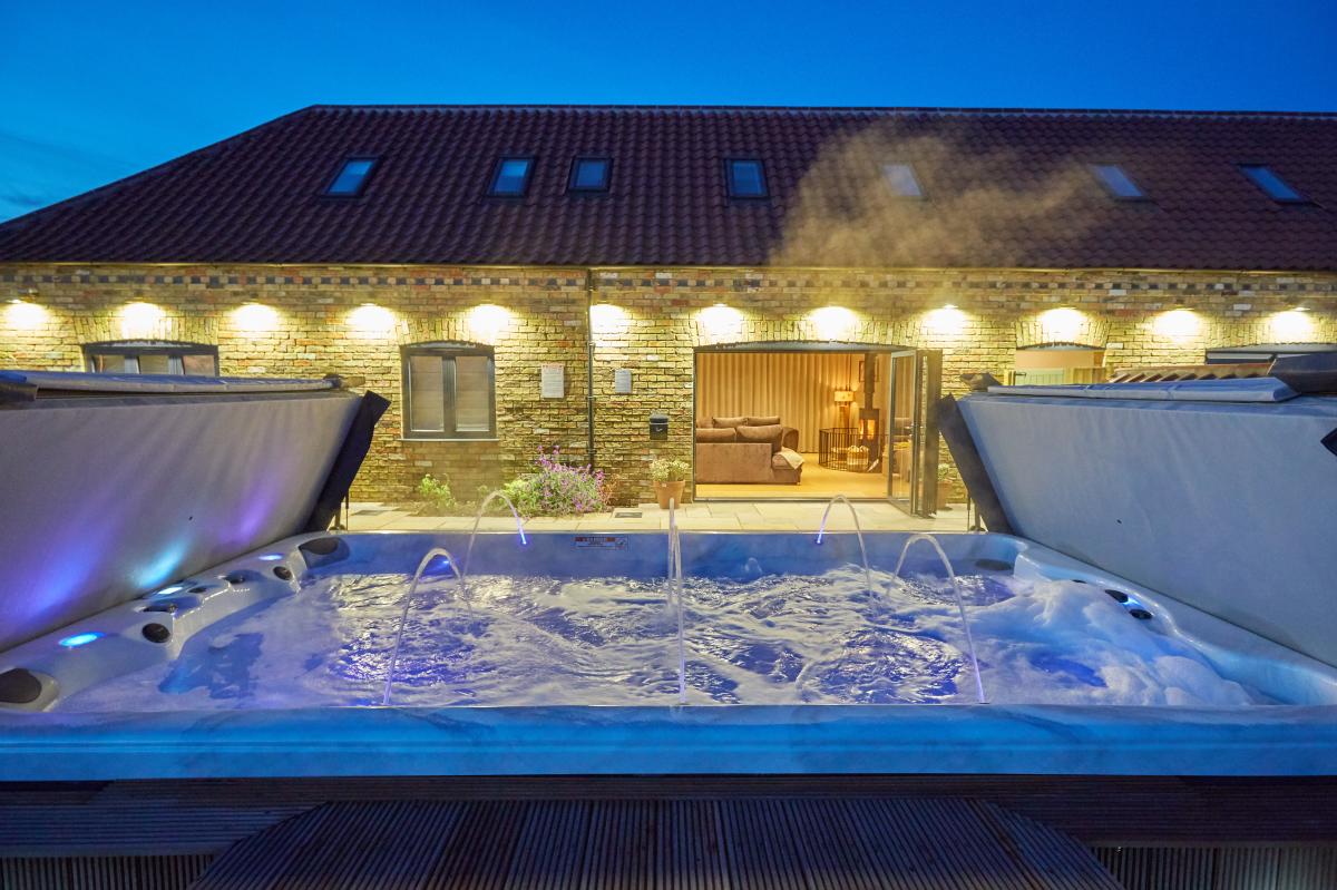 picture of a well lit outdoor hot tub at Ashlin Farm Barns