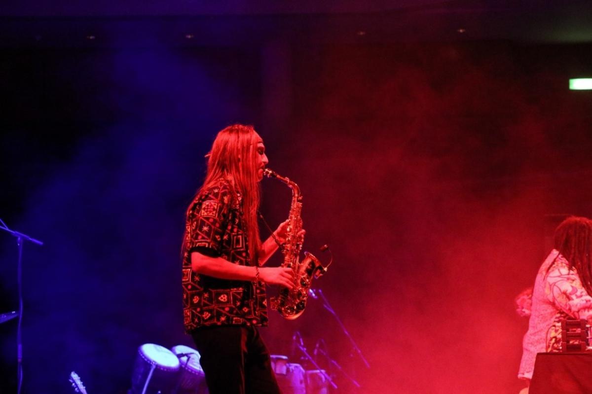 Person playing saxophone on stage at WOMEX
