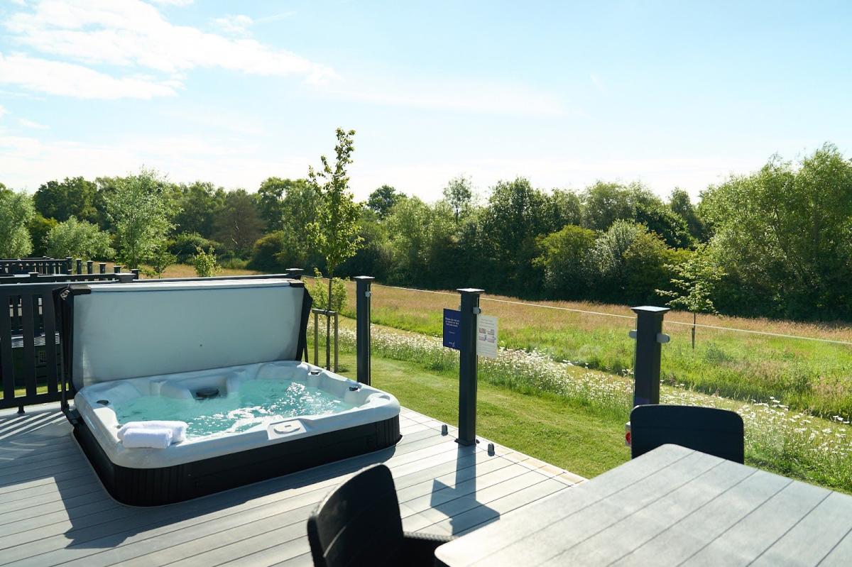 Hot tub and decking of lakeside lodge at Green Hill Farm
