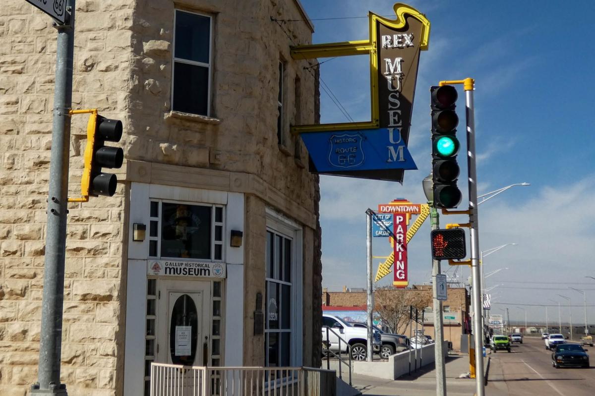 Stone corner building with a vintage Rex Museum sign along Historic Route 66.