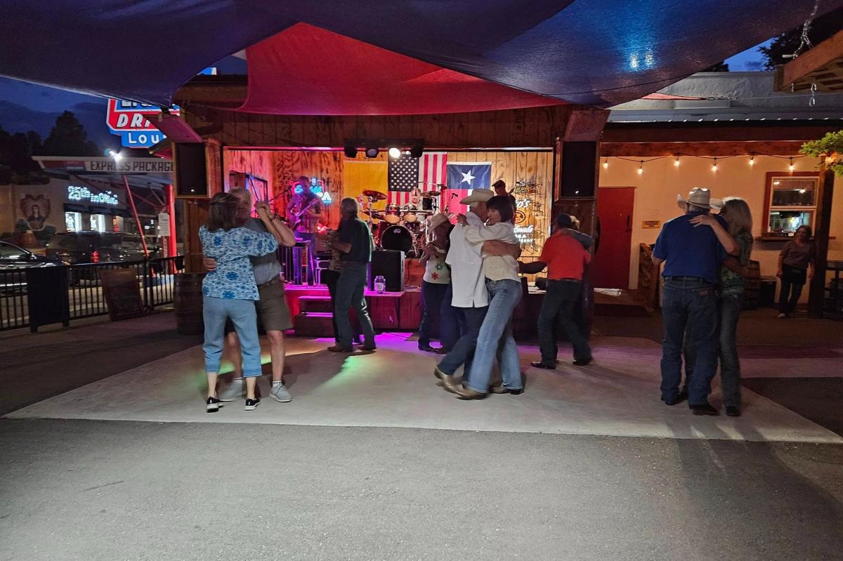 Couples dancing in the outdoor patio at Win Place & Show Bar in Ruidoso.