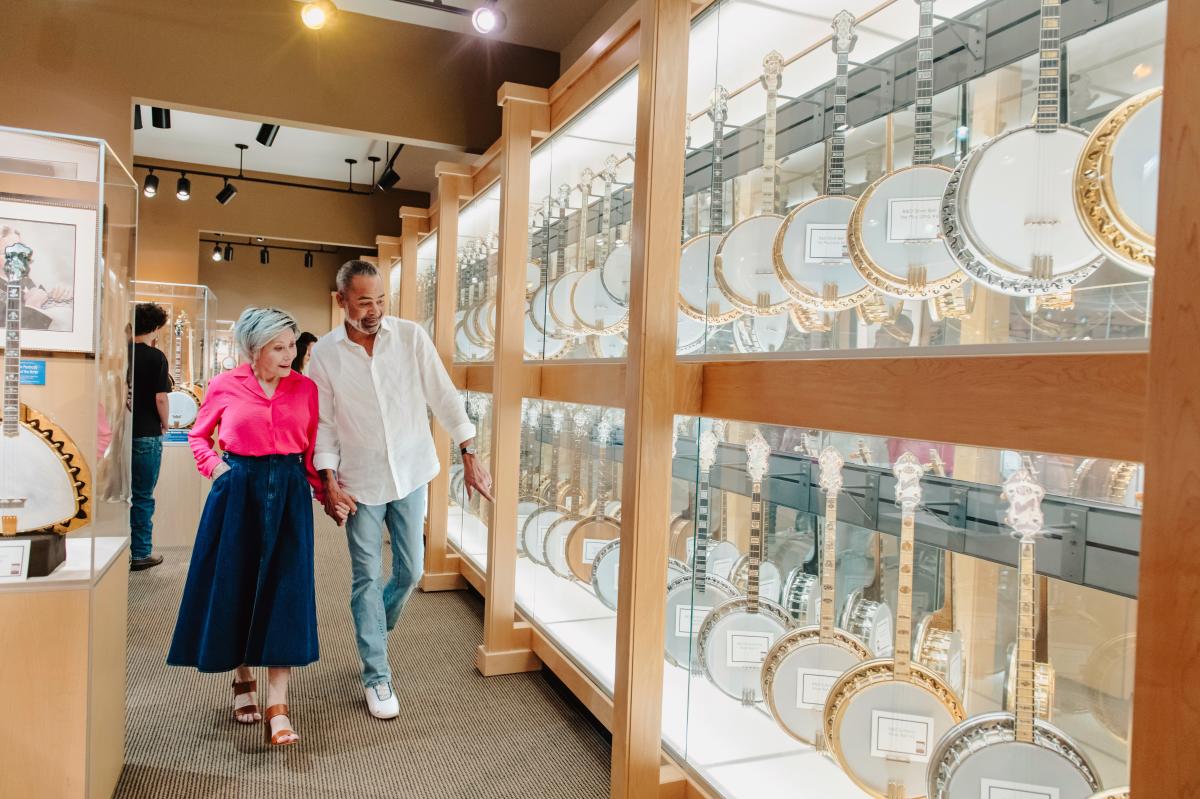 Couple looking at banjos on display at American Banjo Museum