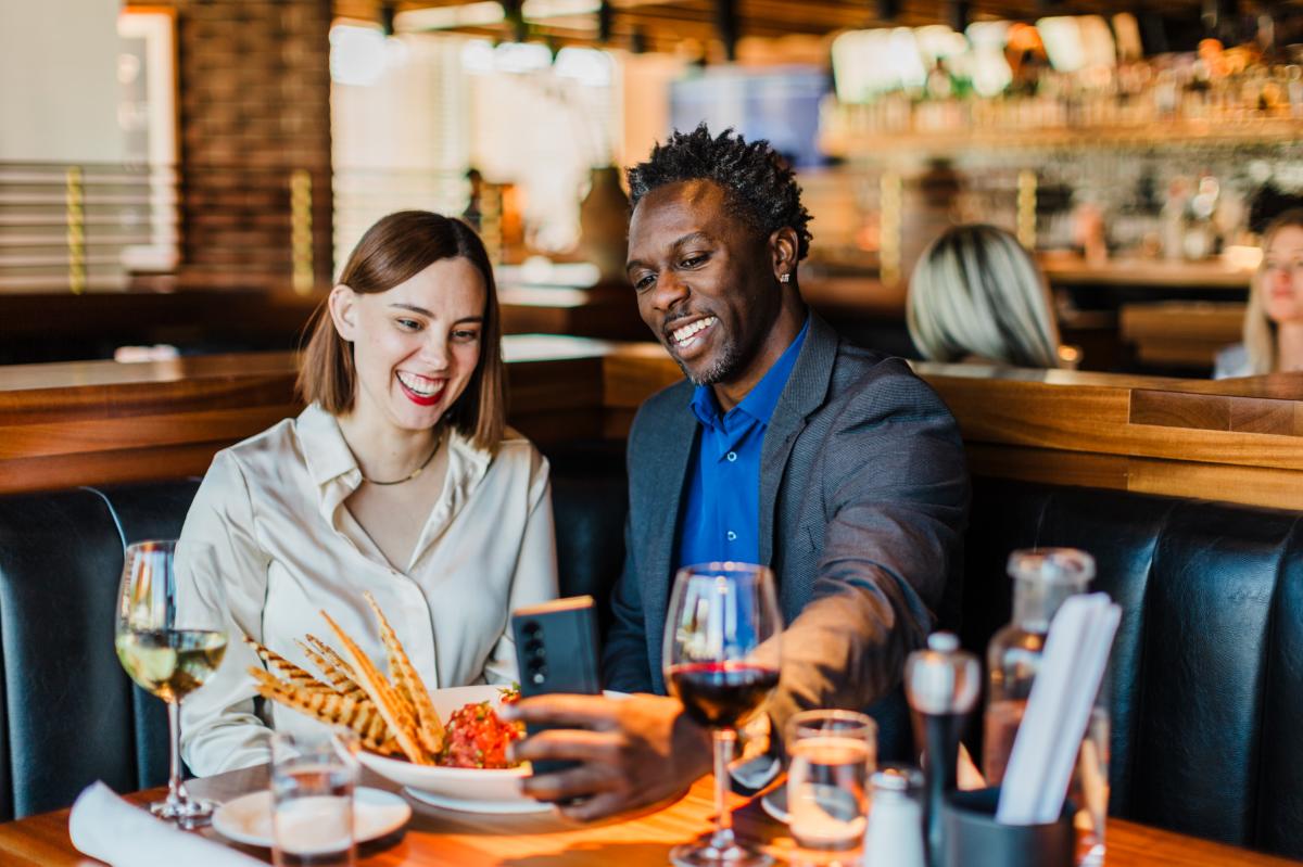Couple sitting eating food and drinking wine at Jimmy B's in Oklahoma City