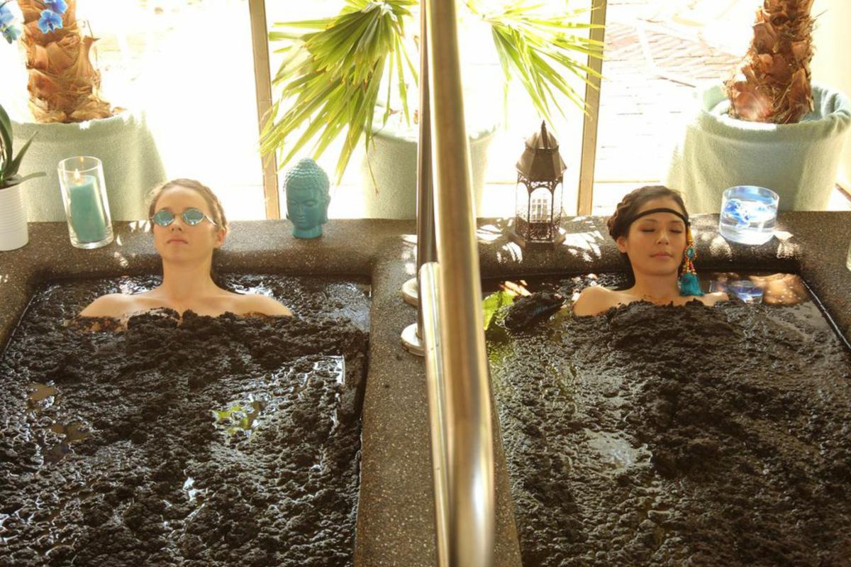 Two Women In A Mud Bath At Two Bunch Palms In Desert Hot Springs, CA