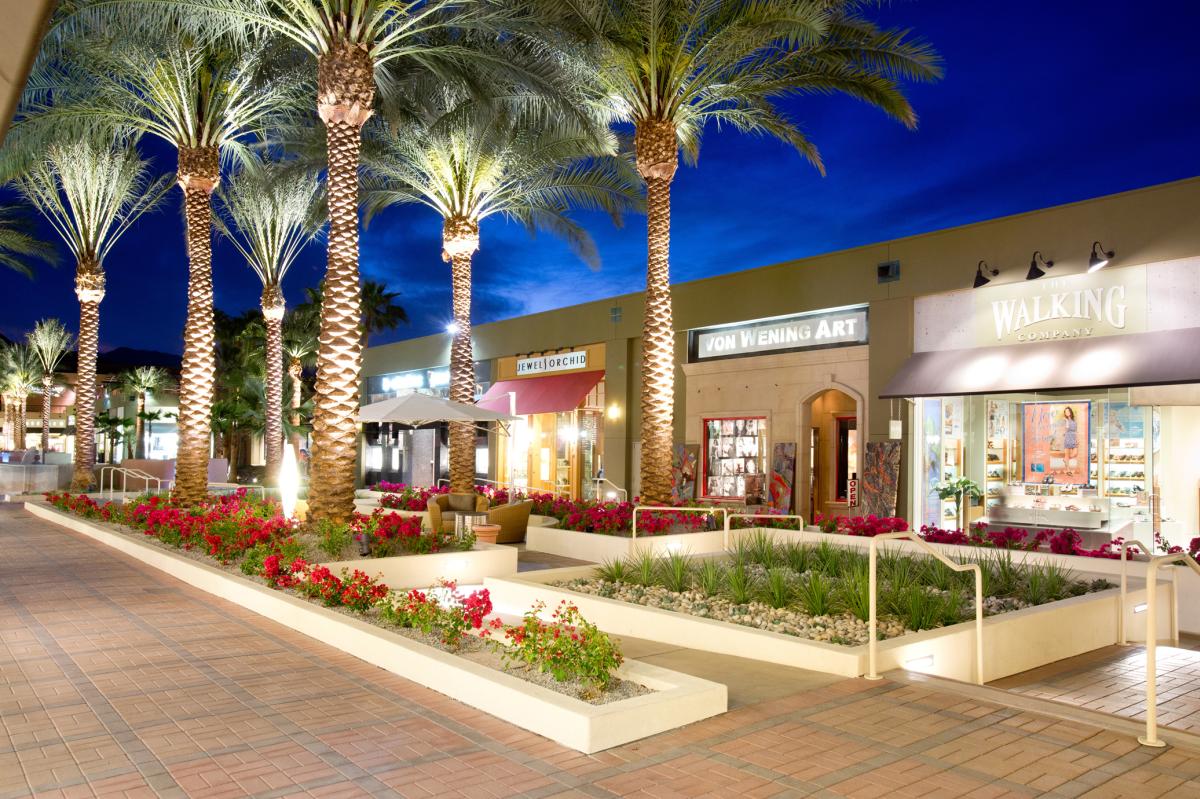 Shopping district and palm trees at dusk