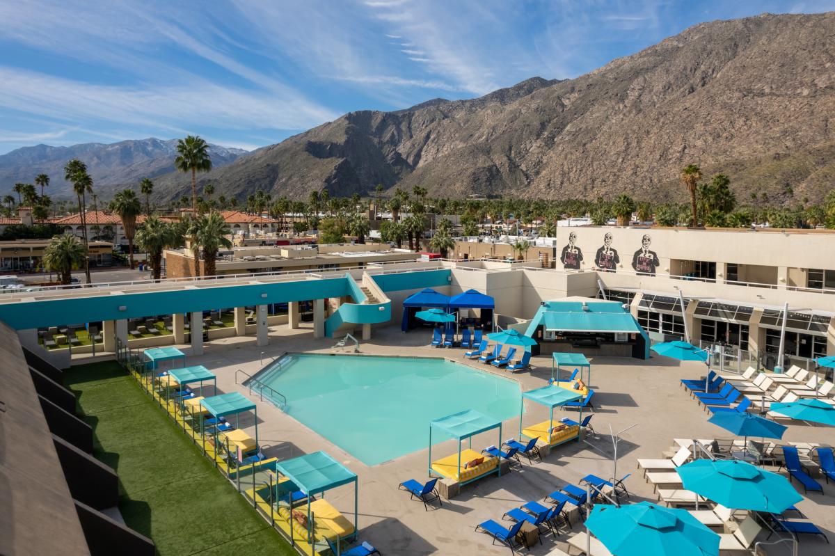 View Of The Pool With Mountains In The Background At Hotel ZOSO In Palm Springs