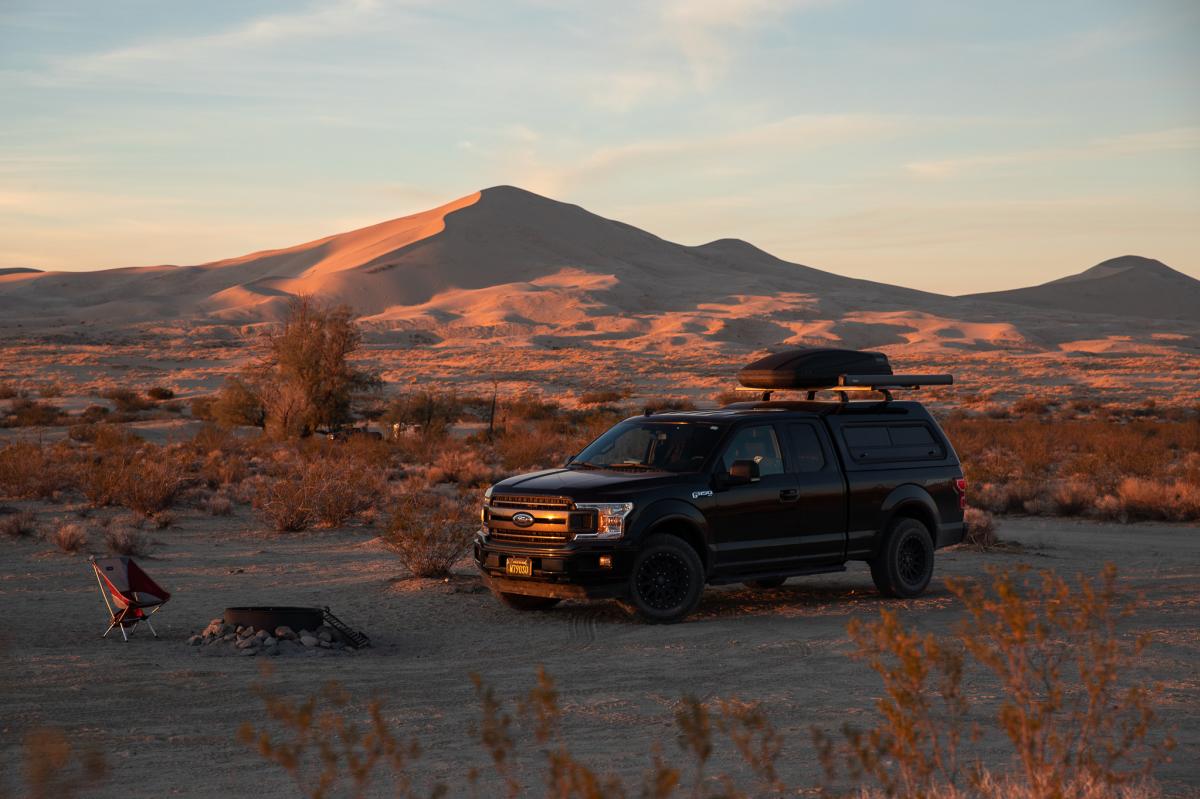 A truck parked at a campsite at the Kelso Dunes in the Mojave National Preserve