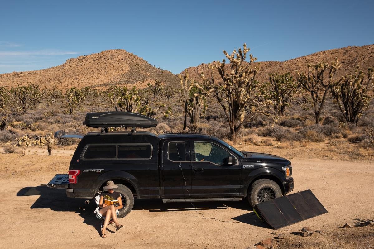 A woman camping at a dispersed campsite in the Mojave National Preserve