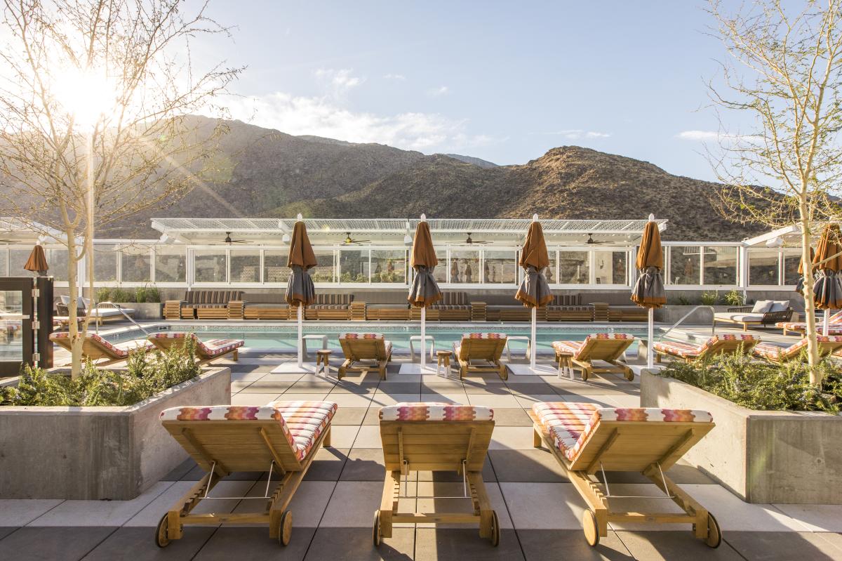 The rooftop pool at Kimpton Rowan Palm Springs with the San Jacinto Mountains in the background.