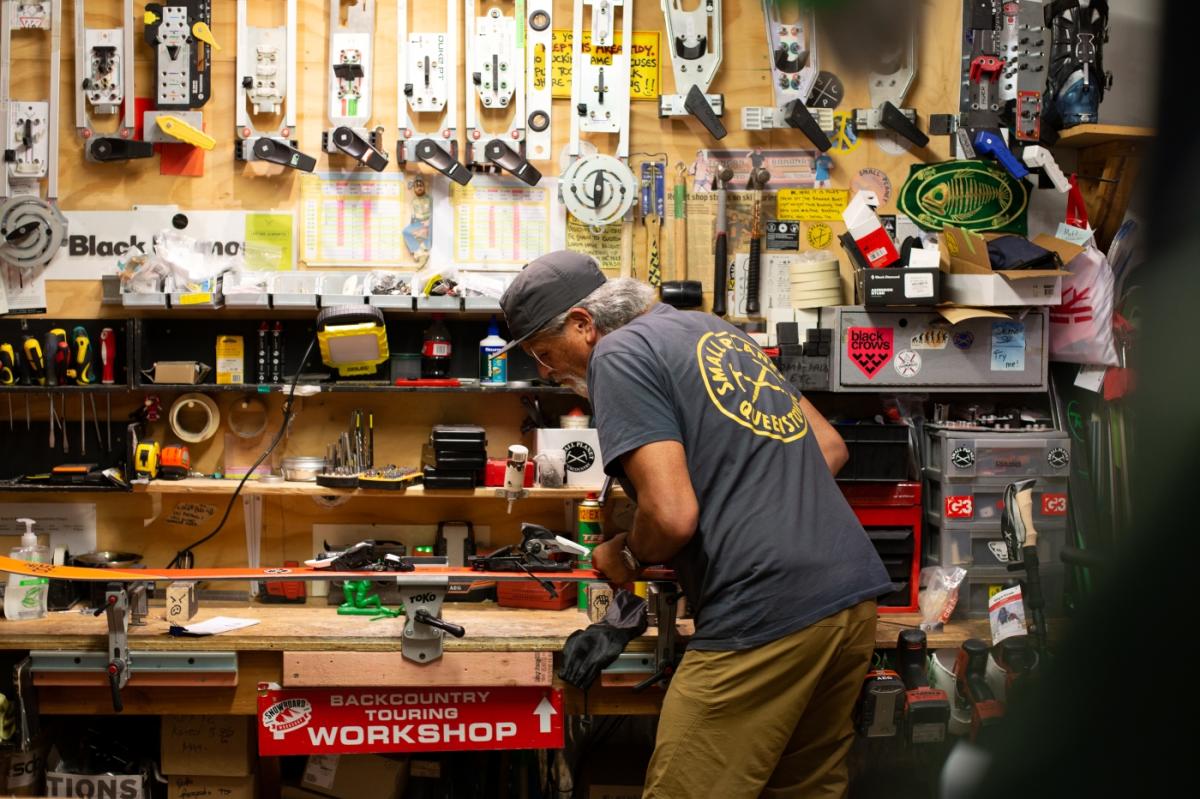 Darryl Tatom, Owner of Small Planet in workshop surrounded by sporting gear