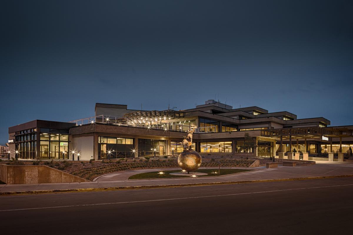 Exterior image of Rapid City Airport from parking lot at night.